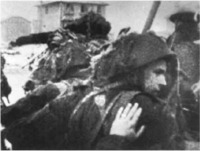 A soldier gives his friend a good luck pat on the back as troops  of the 3rd Canadian Division  land at Nan Sector, Juno Beach, D-Day. 